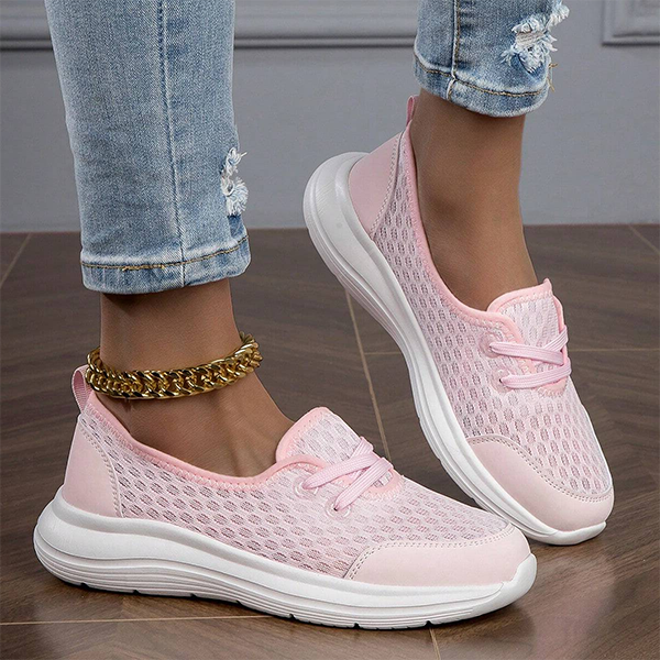 Woman standing in women's soft sole comfort shoes, featuring orthopedic arch support & slip resistance.