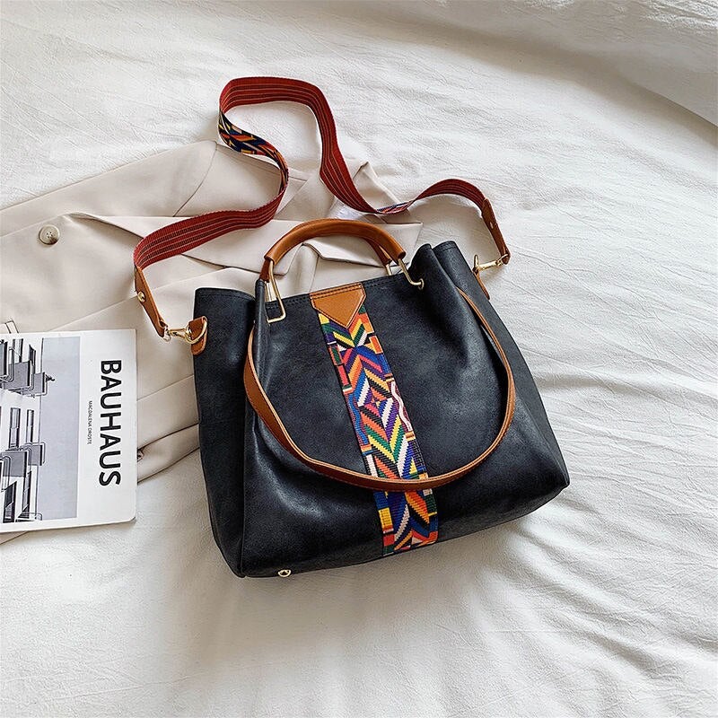 Spacious PU leather tote bag holding daily essentials. Versatile women's everyday carry, work, or travel bag.