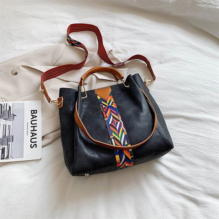 Spacious PU leather tote bag holding daily essentials. Versatile women's everyday carry, work, or travel bag.