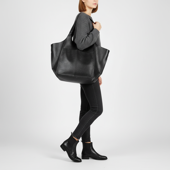 Close-up of the smooth vegan leather texture of this spacious women's everyday tote bag. High quality finish.
