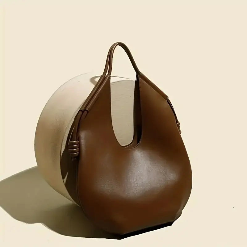 Modern women's travel tote, large capacity vegan leather shoulder bag with chic style.
