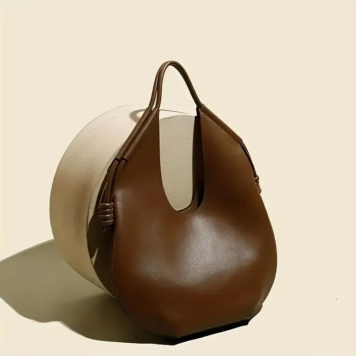 Modern women's travel tote, large capacity vegan leather shoulder bag with chic style.