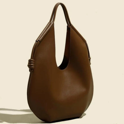 Everyday spacious women's vegan leather tote, a minimalist and chic carryall shoulder bag.