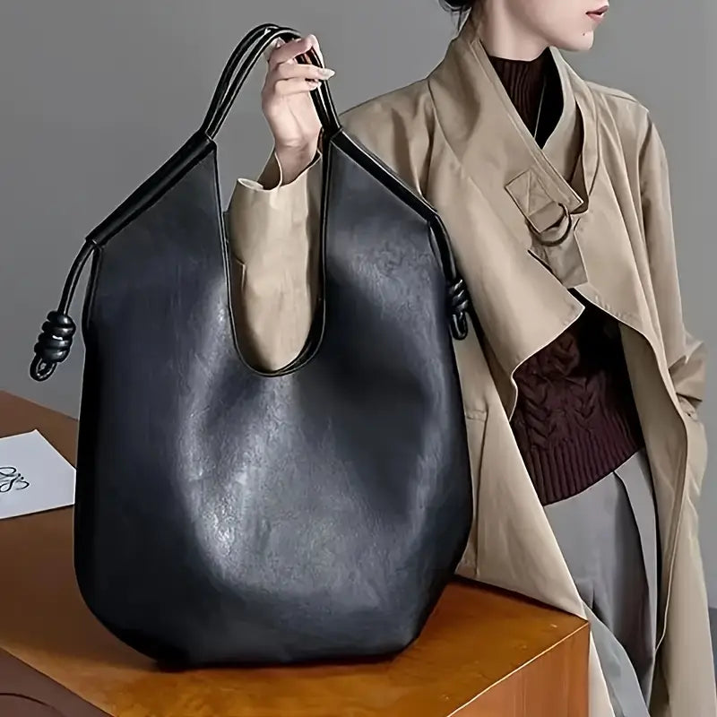 Elegant women's travel tote in vegan leather, a spacious and durable carryall.