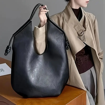 Elegant women's travel tote in vegan leather, a spacious and durable carryall.