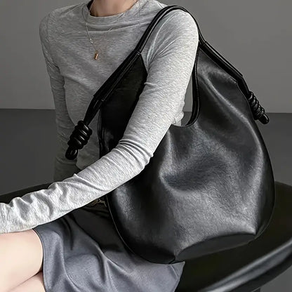 Minimalist style women's vegan leather bag, perfect as an everyday shoulder tote.