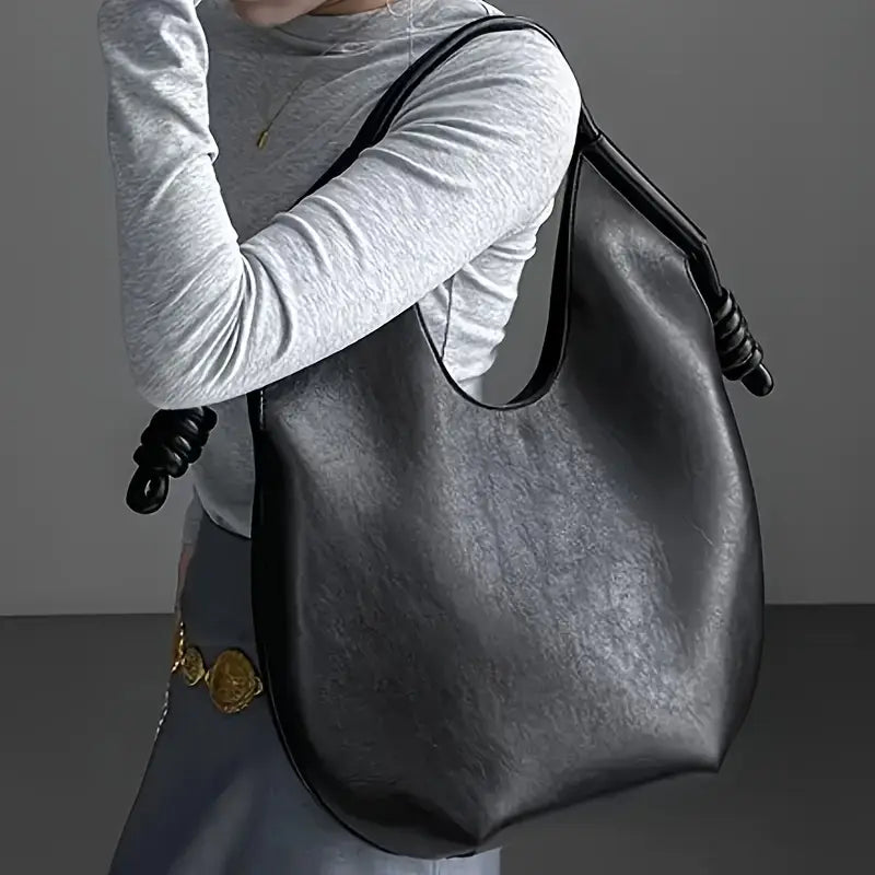 Spacious women's carryall tote, chic vegan leather bag for work, travel, or daily essentials.
