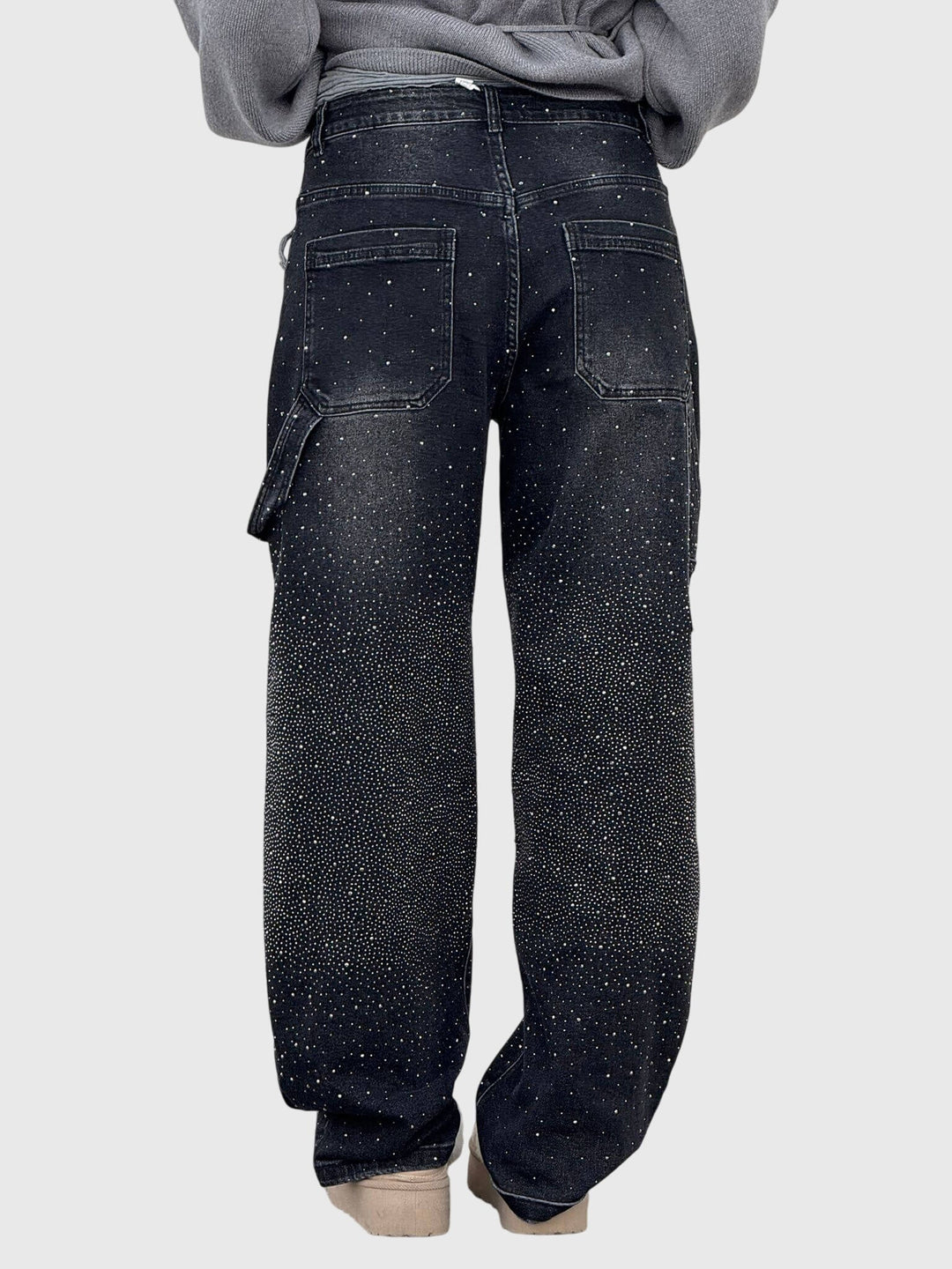 Side view of women's sparkling diamond loose fit pants, showcasing elegant drape.