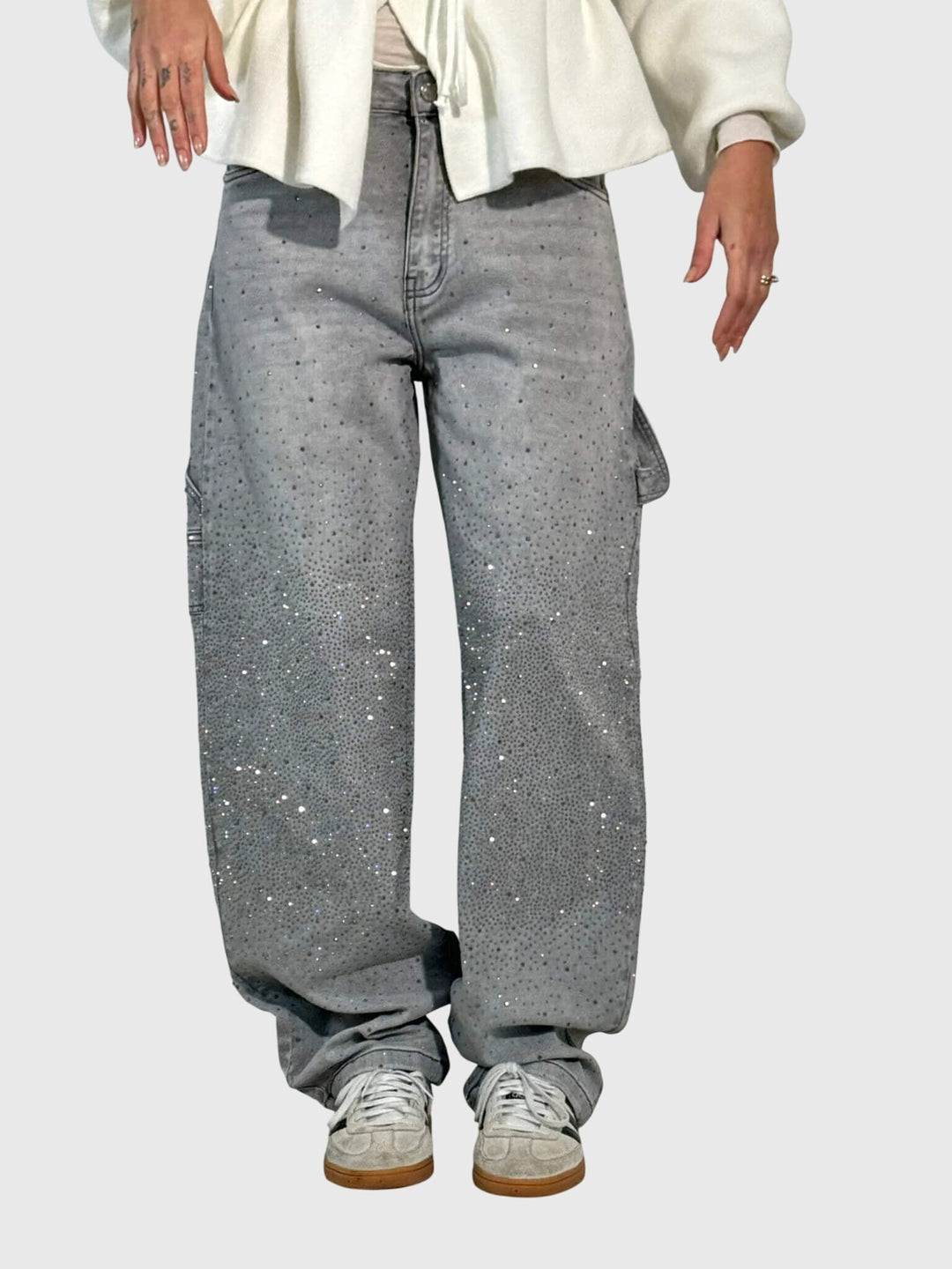 Detail shot of the sparkling diamond embellishments on women's loose fit pants.