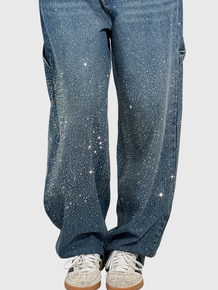 Close-up of sparkling diamond details on comfortable women's loose fit pants.