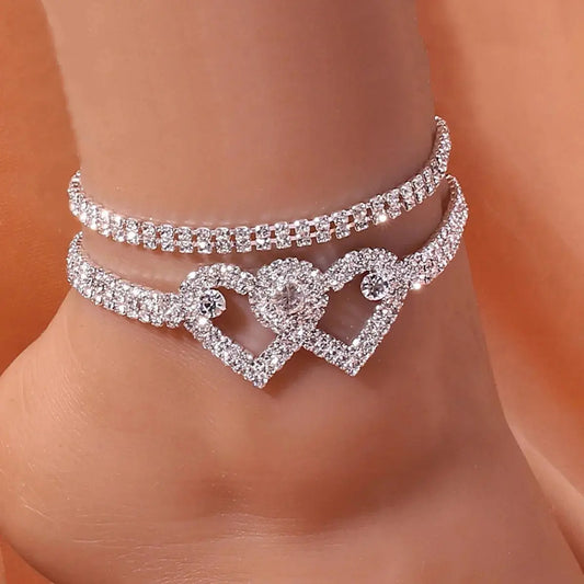 Women's sparkling rhinestone heart leg chain. Fashion body jewelry accessory for elegant styling.