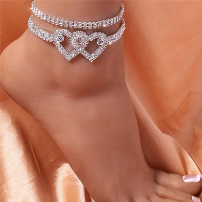 Rhinestone heart leg chain for women. Shimmering body jewelry accessory, perfect for fashion looks.