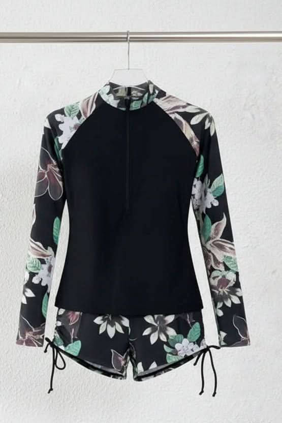 Vibrant tropical print on women's sporty rashguard swimsuit, a stylish choice for summer beach and pool attire.