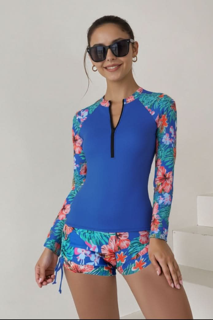 Active women's two-piece tropical rashguard swimsuit designed for surfing, paddleboarding & beach sports.