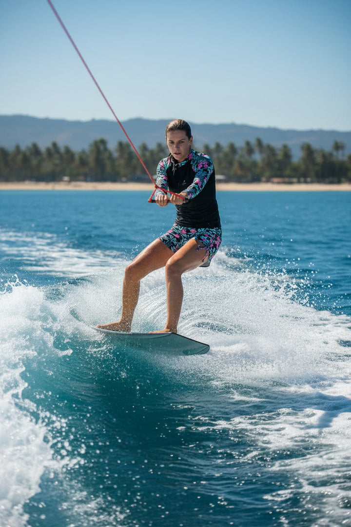Women's sporty tropical rashguard swimsuit with an adjustable fit, comfy for active pool and beach days.