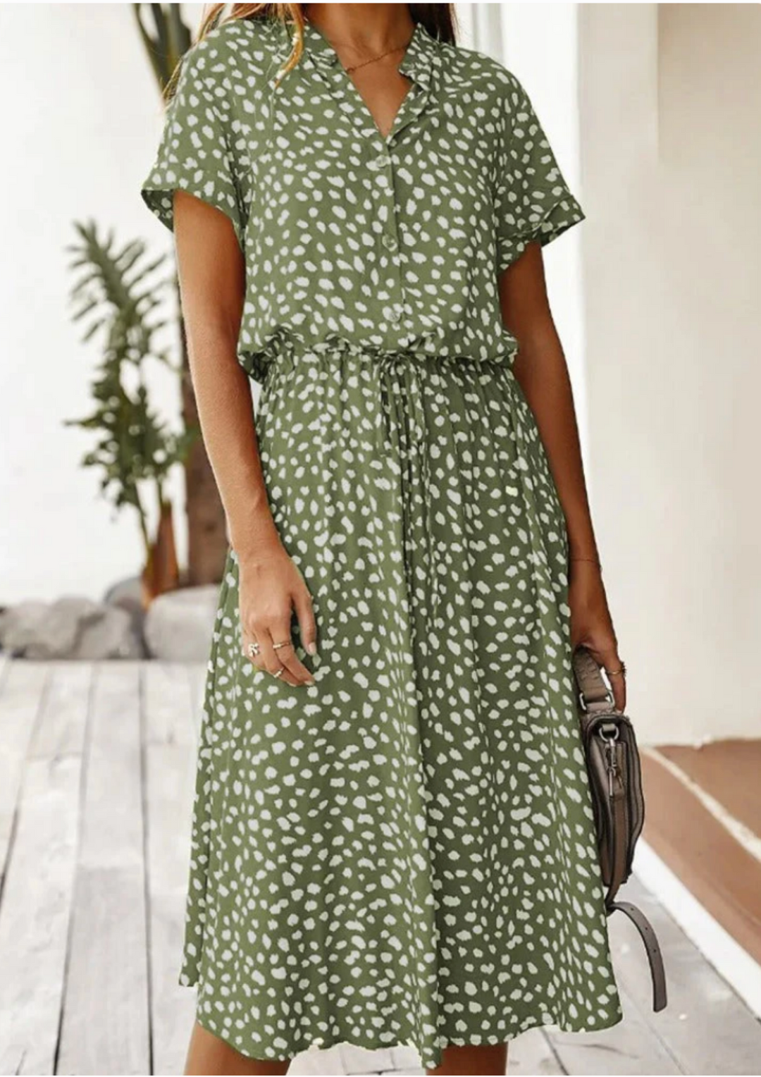 Women's spotted print V-neck midi dress with decorative buttons & comfortable flowy design.