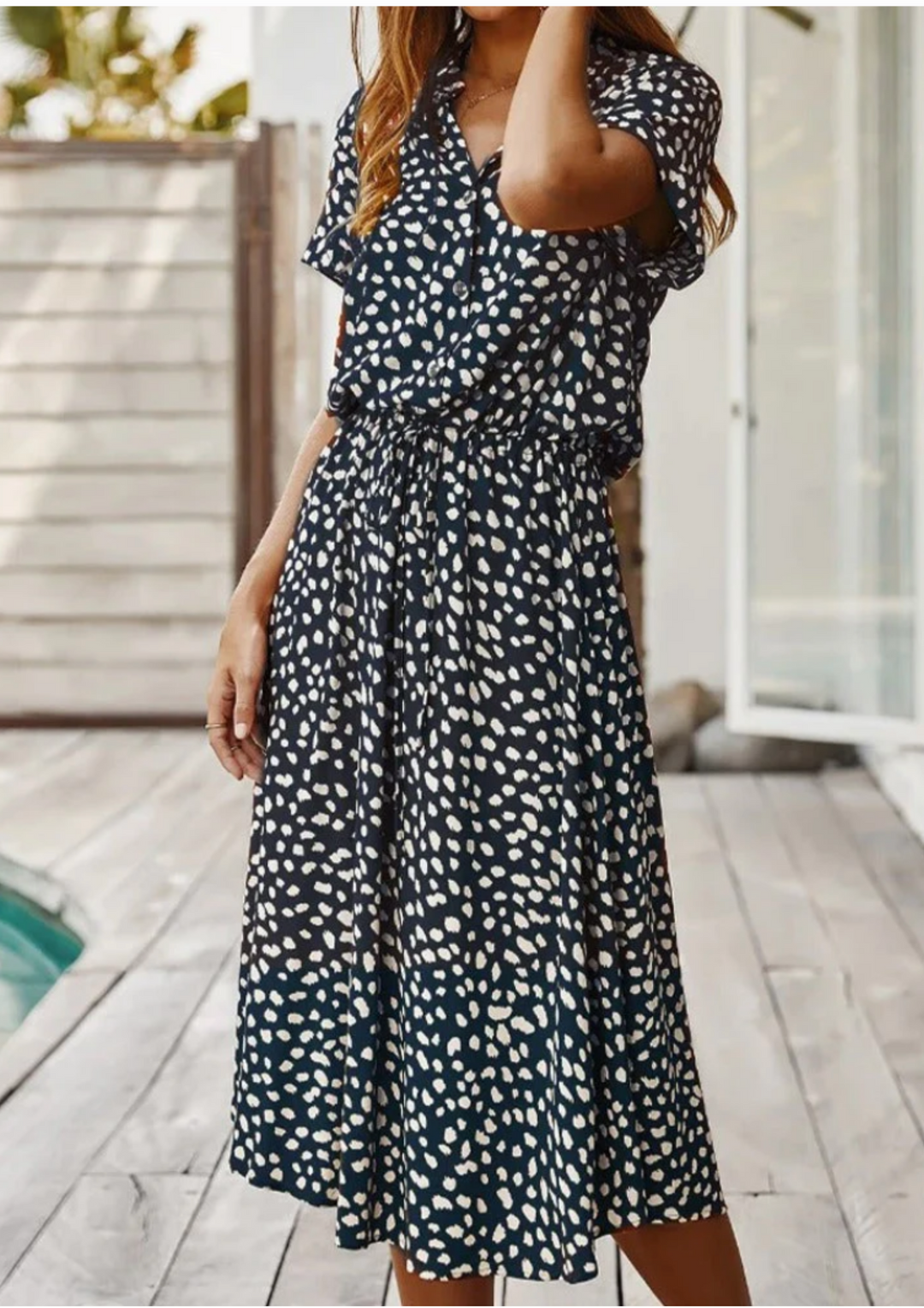 Women's summer fashion: spotted print midi dress with elegant button details & flutter sleeves.