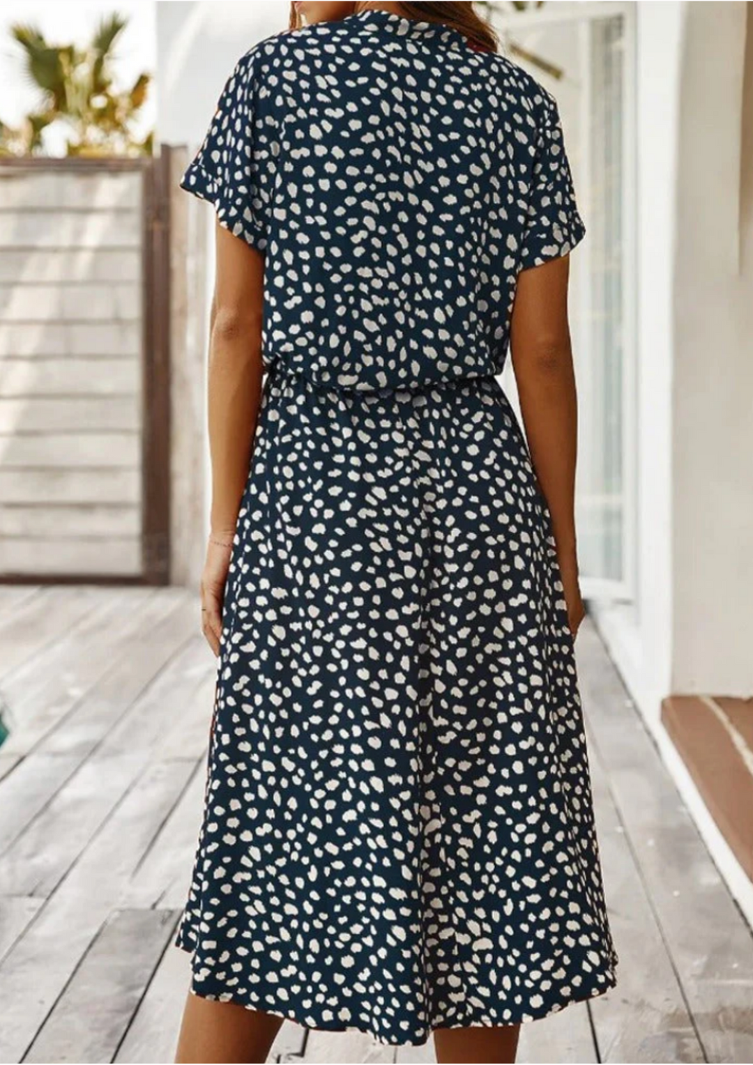V-neck women's midi dress in spotted print, with functional buttons & an adjustable waist for comfort.
