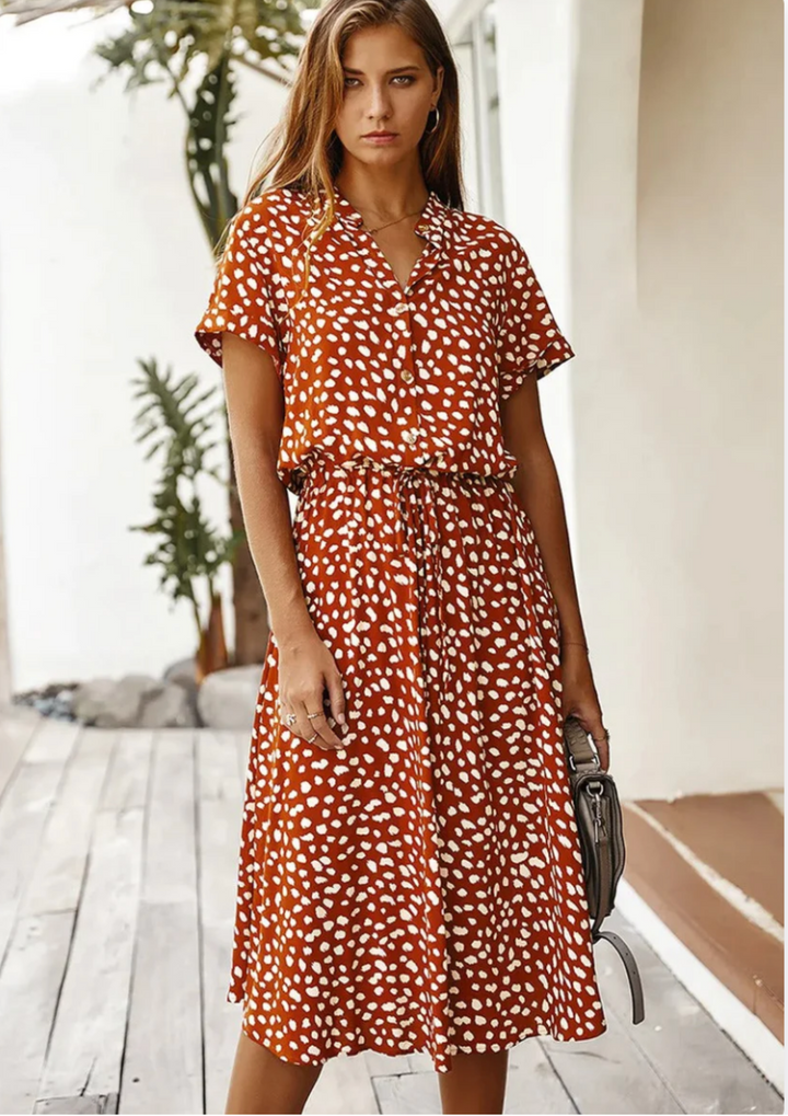 Elegant spotted print midi dress for women, with a button front, flutter sleeves & flowy skirt.