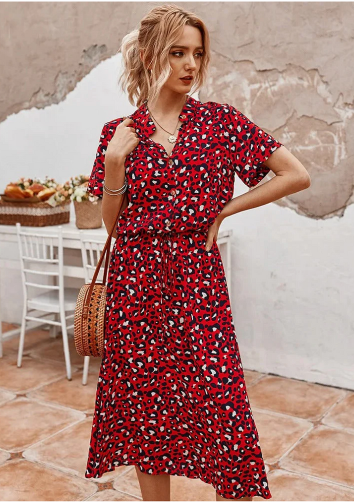 Stylish women's spotted print midi dress with functional buttons, V-neck, and flutter sleeves.