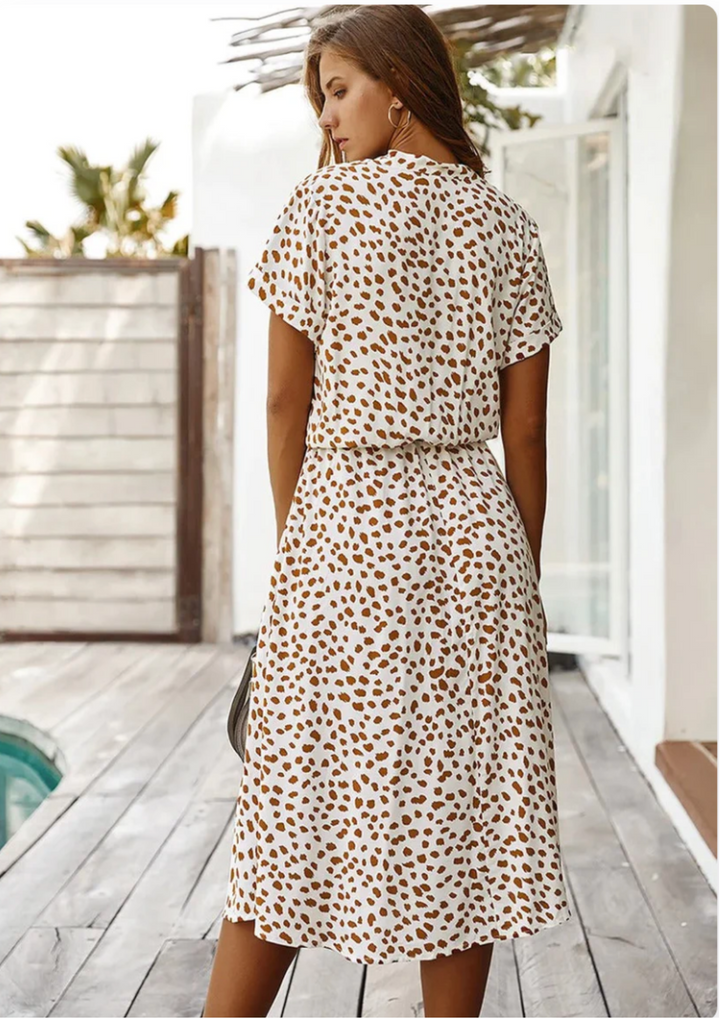 Fashionable women's spotted print midi dress with flutter sleeves, adjustable waist & button detail.