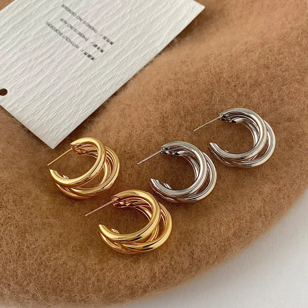 Hypoallergenic women's stacked hoops, combining shiny gold and silver metal in a unique layered style.