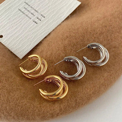 Hypoallergenic women's stacked hoops, combining shiny gold and silver metal in a unique layered style.