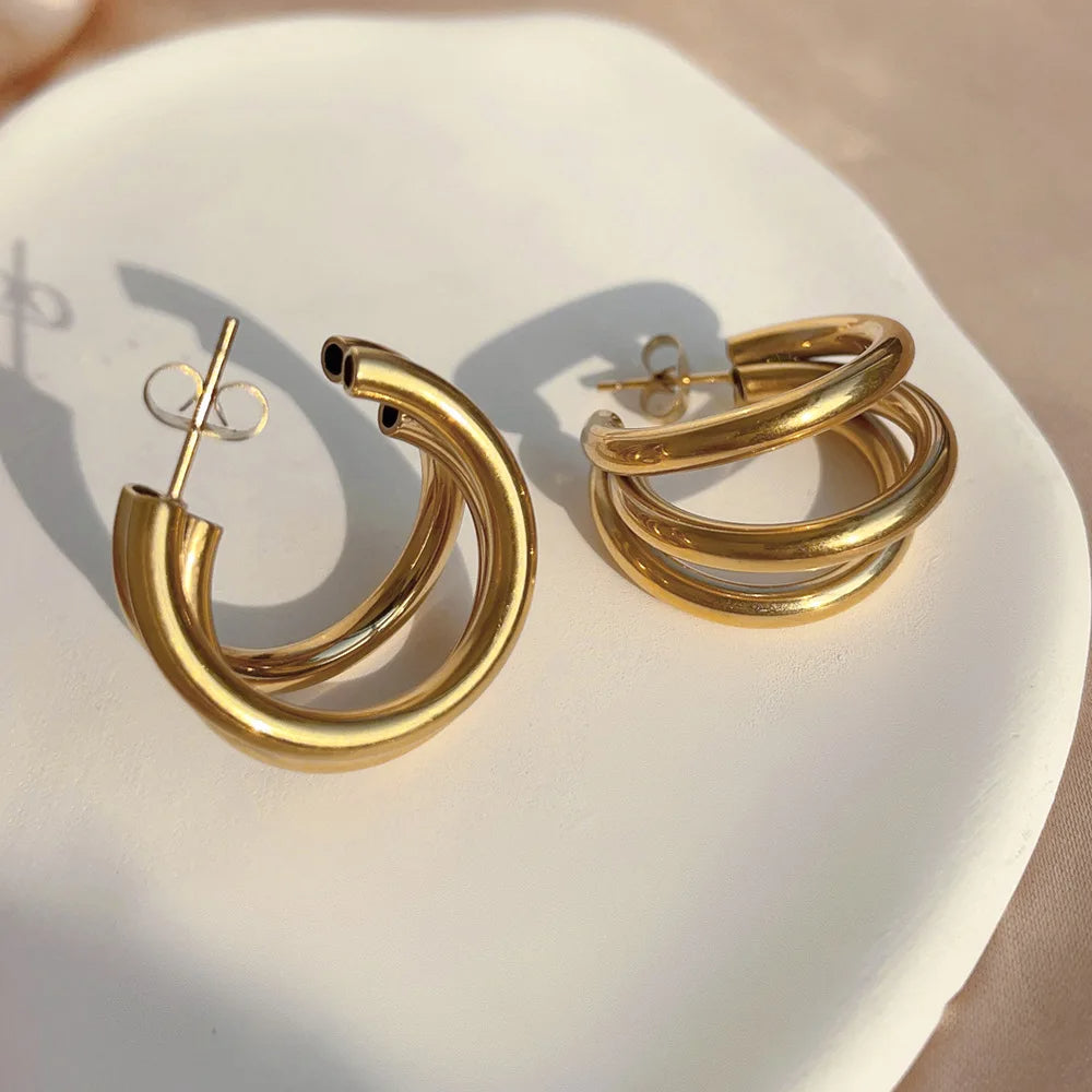 Fashionable women's stacked hoop earrings with a chic gold and silver mixed metal look.