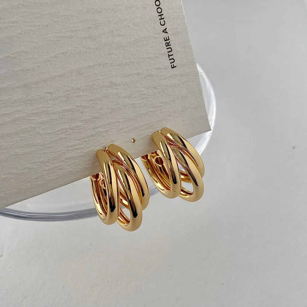 Sophisticated gold and silver stacked hoop earrings for women, a modern layered jewelry statement.