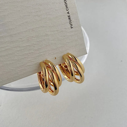 Sophisticated gold and silver stacked hoop earrings for women, a modern layered jewelry statement.