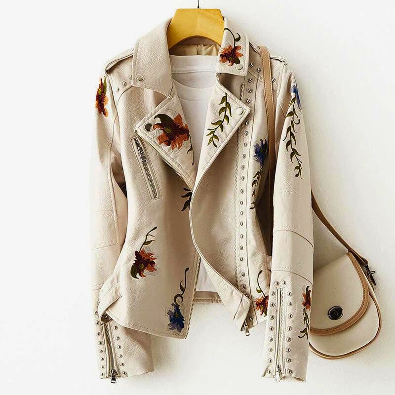Women's statement jacket with elaborate floral embroidery, edgy studs, and unique design. Perfect fashion-forward outerwear.