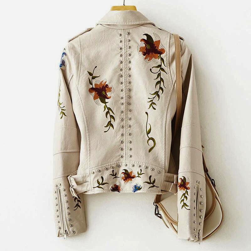 Edgy women's statement jacket. Distinctive floral embroidery & studded design make this outerwear unique & fashion-forward.