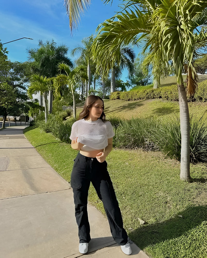 Woman wearing stylish straight fit cargo pants with adjustable waist. Perfect for trendy streetwear looks.