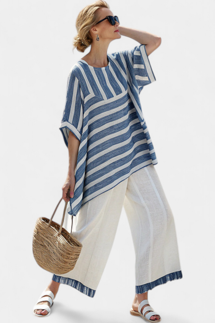 Fashionable women's striped batwing top with asymmetric hem & flowing wide leg pants two-piece set.