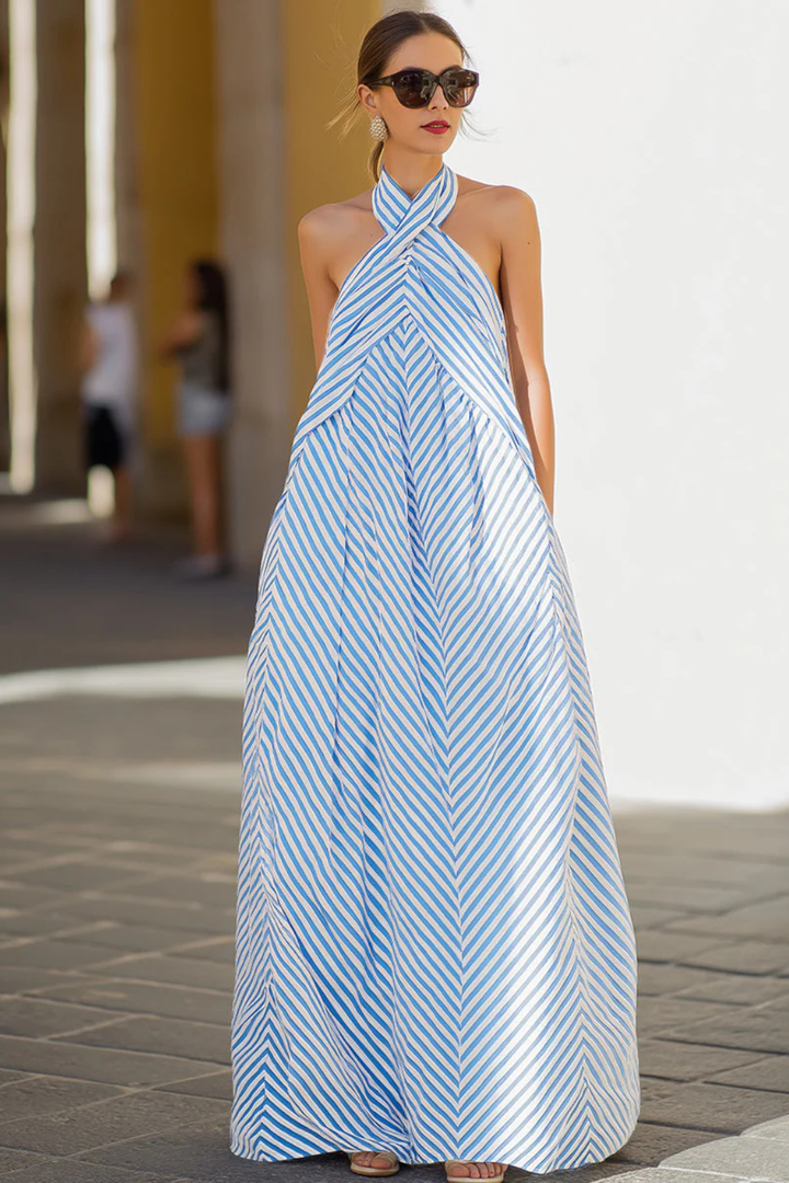Full-length women's striped halter neck maxi dress, showcasing relaxed fit, A-line silhouette, and summer style.