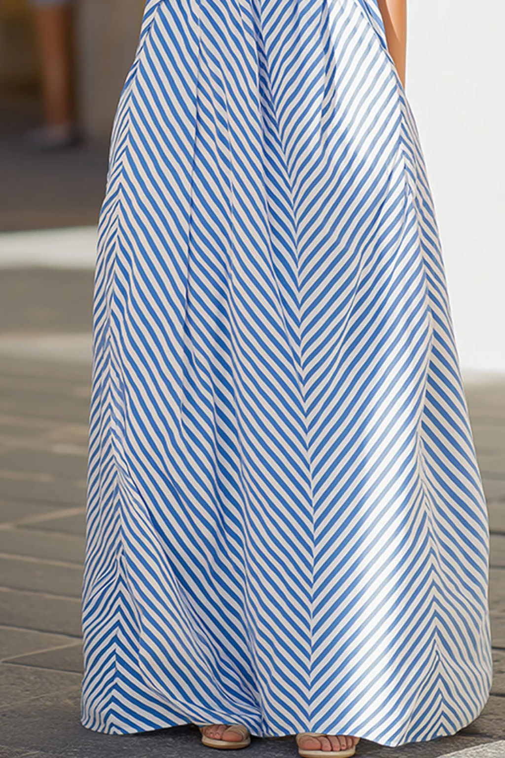 Fashionable women's striped maxi dress with a chic halter neck, perfect as a relaxed summer beach or casual sundress.