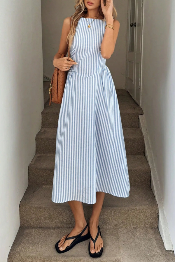Women's striped halter neck midi dress, perfect for summer. Flattering, sleeveless design.