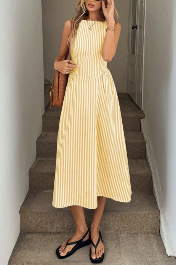 Sleeveless striped midi dress for women with a chic halter neckline. Flattering summer fashion.