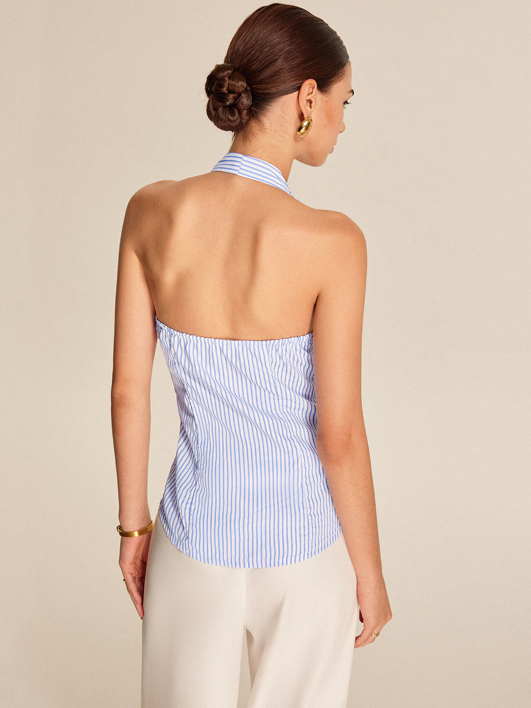 Chic women's striped halter top, sleeveless blouse with a fashionable tie front detail, ideal for summer.