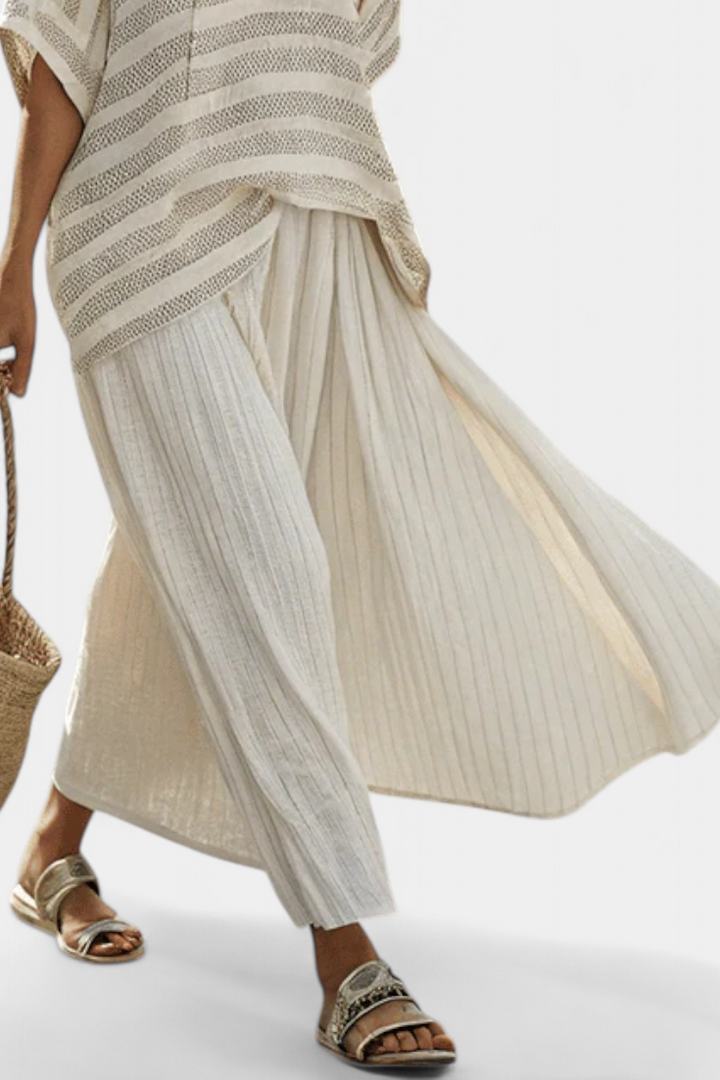 Stylish women's striped knit top and flowy maxi skirt set, ideal for spring fashion, vacation wear, or versatile outfits.