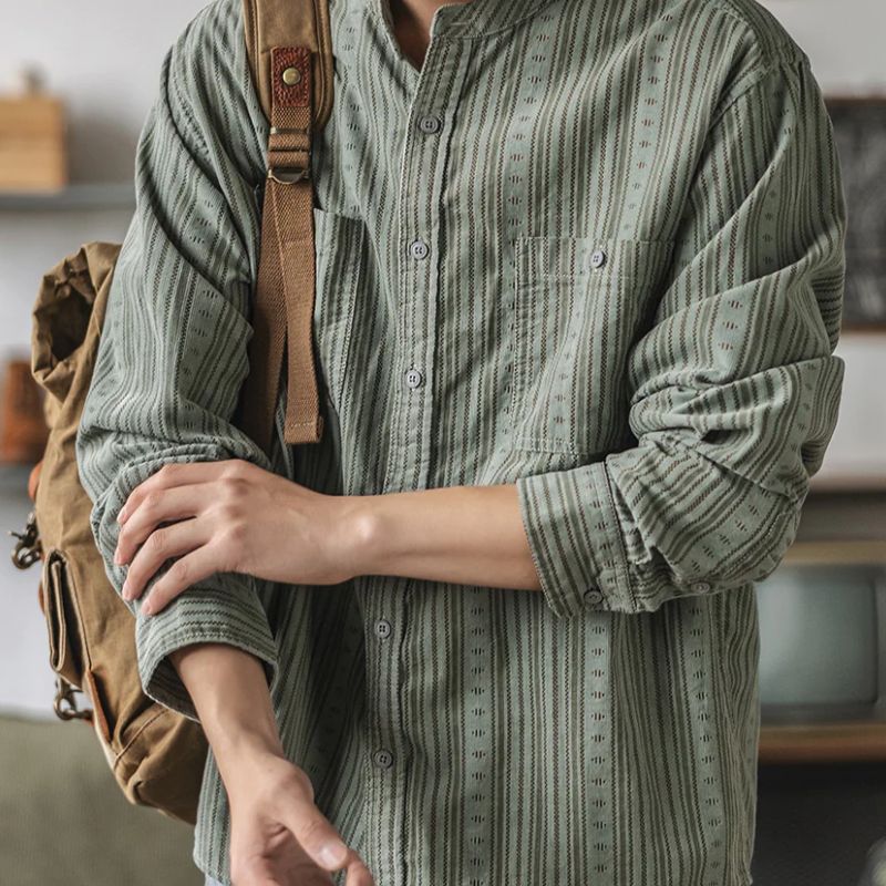Stylish women's relaxed fit striped shirt, versatile for spring & summer fashion, classic casual top.