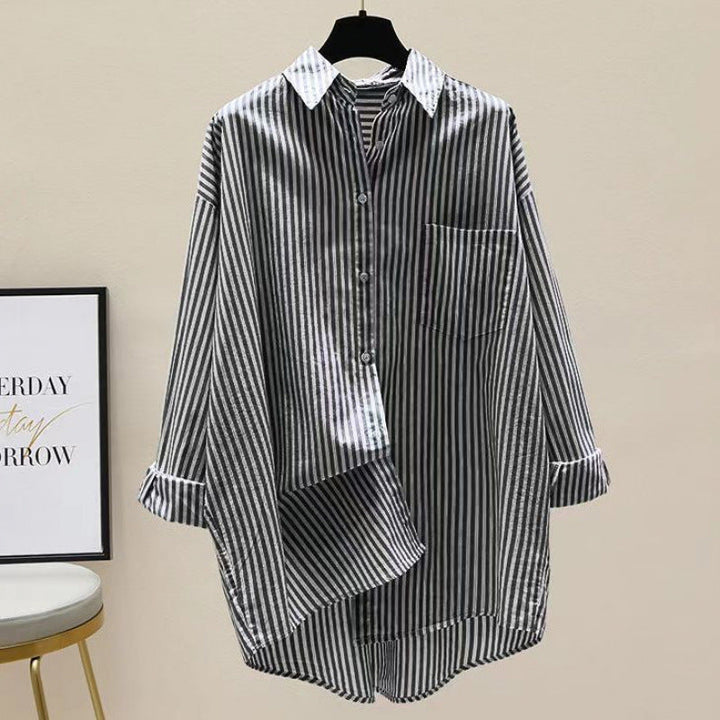 Fashionable women's striped oversized button-down shirt with dropped shoulders, chest pocket & longline design. Casual chic.