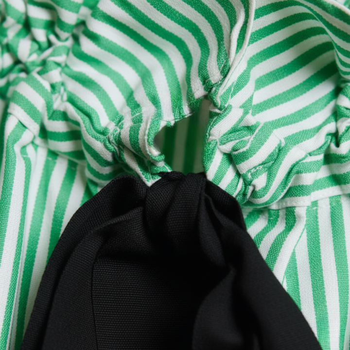 Elegant women's striped top with delicate ruffles & bow tie, a versatile formal blouse.