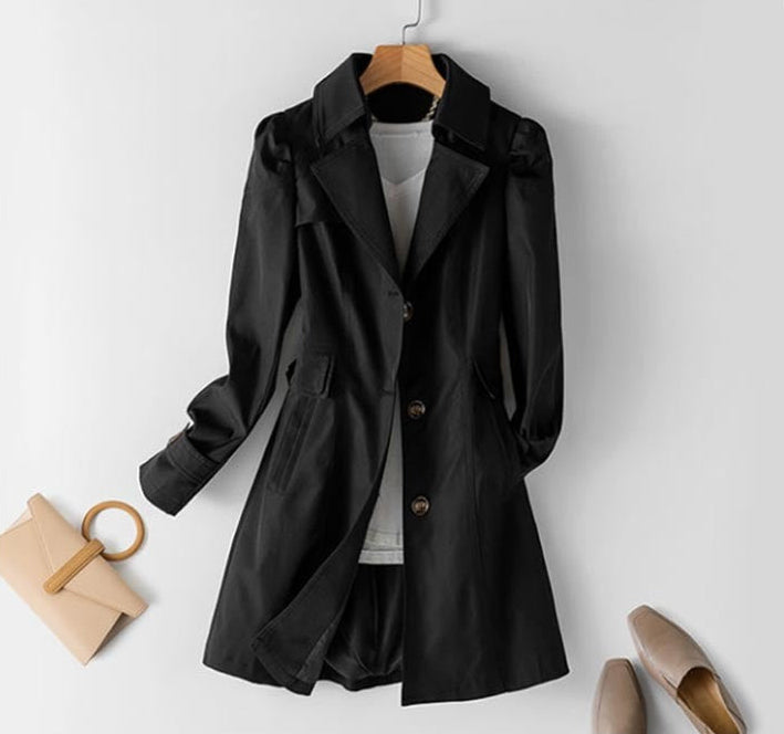 Chic ivory structured trench coat for women with button closure, a modern and versatile spring-fall outerwear piece.