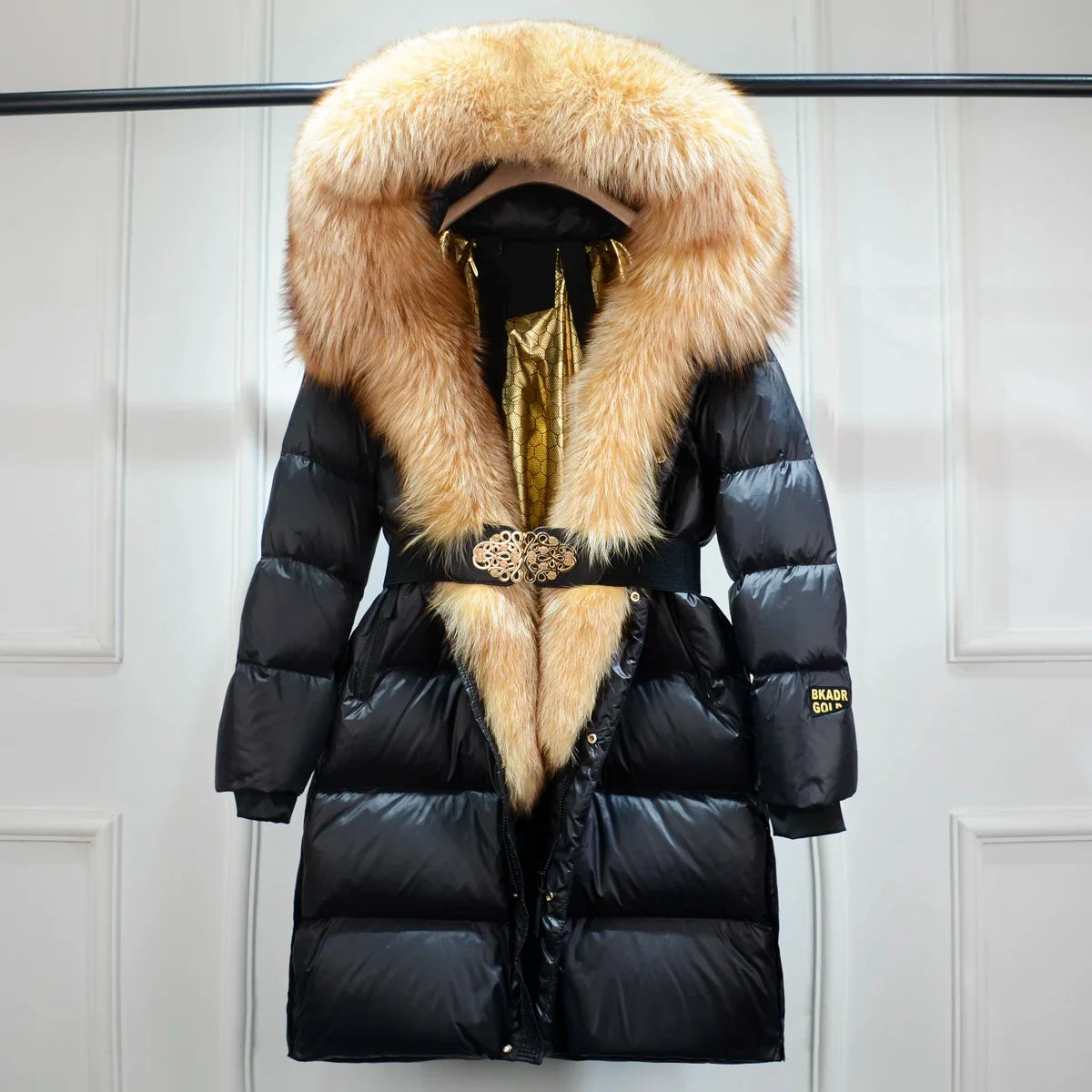 Fashionable women's belted puffer jacket. Warm, long coat with a sleek design, ideal for casual winter wear.