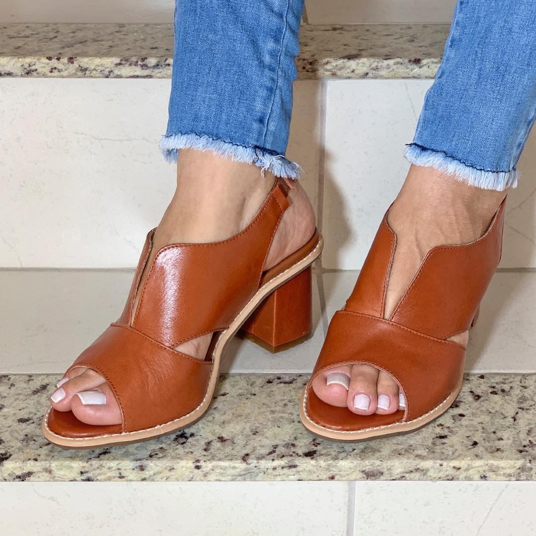 Elegant women's heeled sandals with comfortable block heel and secure buckle closure.
