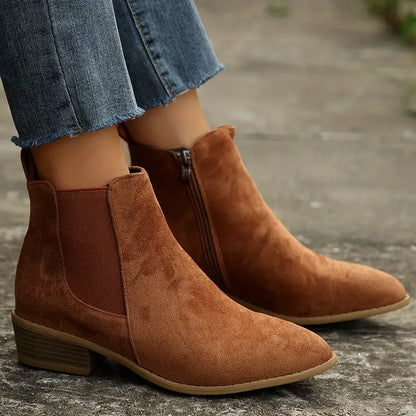 Durable women's pull-on ankle boots, black Chelsea design with comfortable fit for winter fashion.