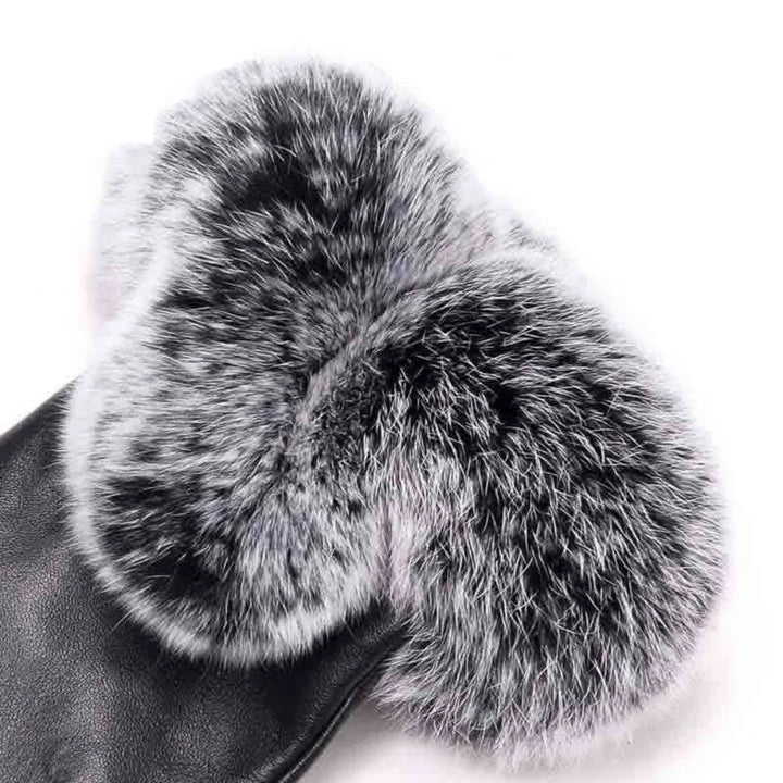Close-up of women's fashion gloves showcasing the shiny PU leather and soft, fluffy faux fur trim.