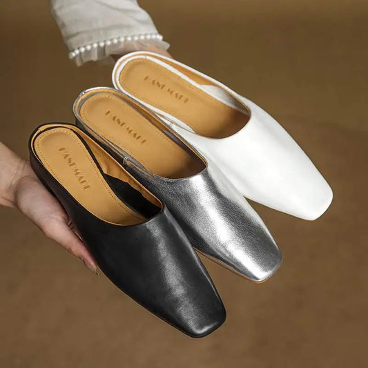 Women's stylish black square-toe mules with comfortable low block heel for casual chic wear.