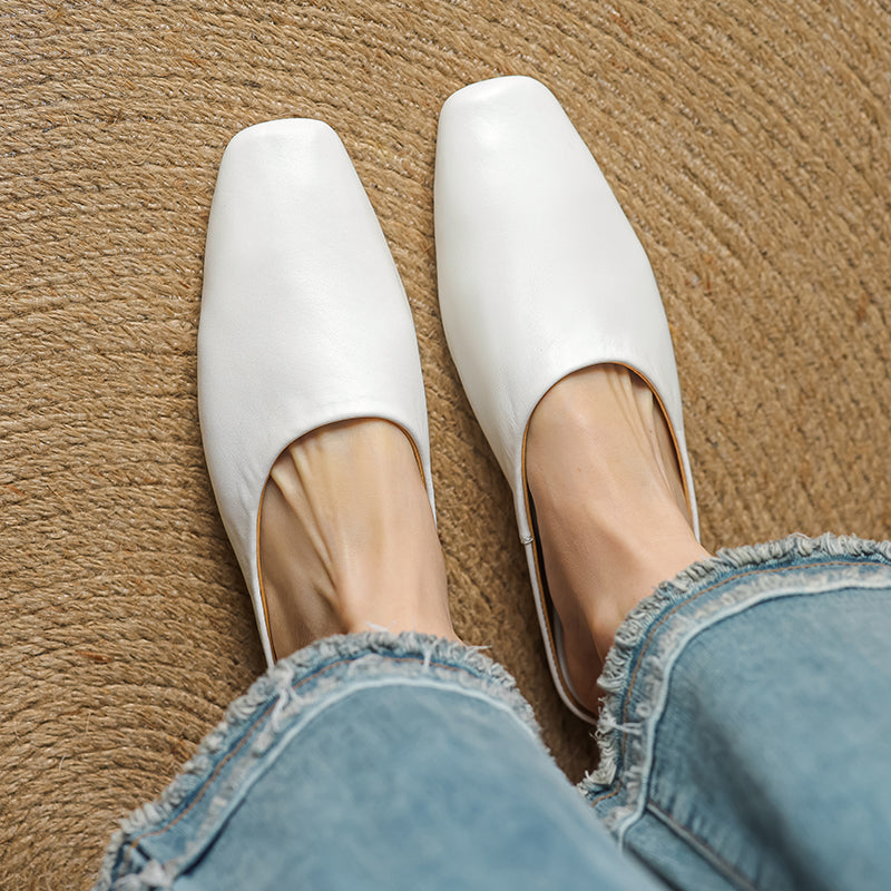Stylish white square-toe mules with a comfortable block heel, a must-have for modern women.
